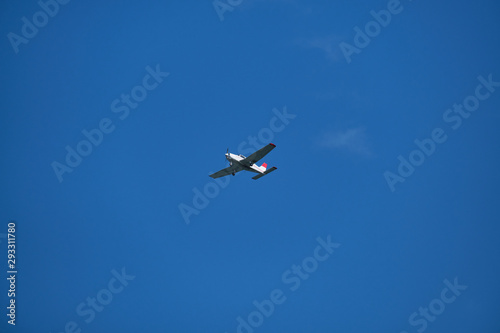 Single engine plane in the blue sky  bottom view