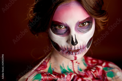 attractive young woman with sugar skull Halloween makeup