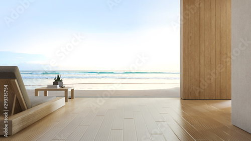 Sea view terrace and bed in modern luxury beach house with blue sky background. Lounge chair on wooden deck at vacation home or hotel. 3d rendering of tourist resort.