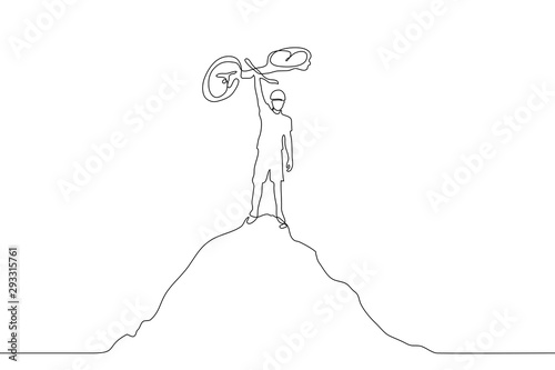 A continuous line drawing of a cyclist standing on top of a mountain and holding his bike as a sign of triumph. The concept of victory, completion, result of labor. It can be used for animation.