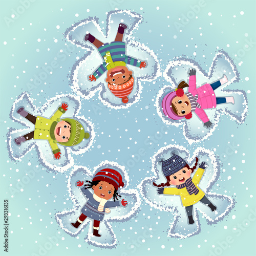 Top view of kids lying and making snow angel on snow in winter day.