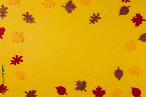 Autumn concept.Paper leaves on a yellow background