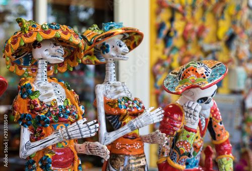 Traditional Mexican skulls, Calaveras, skeletons, La Muerte masks and other scary death symbols of the Day of the Dead, Dia de los Muertos, Halloween, popular souvenirs sold in Mexico.