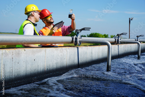                      Engineers controlling a quality of water ,aerated activated sludge tank at a waste water treatment plant 