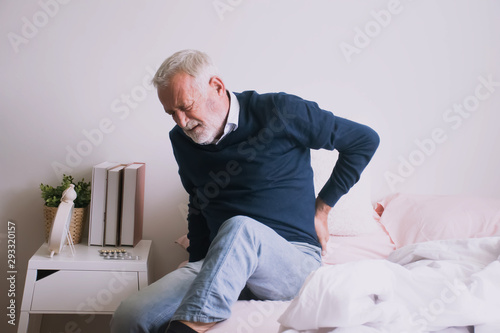 Old man with back ache clasping  . Man suffering from ribbing pain or waist pain.