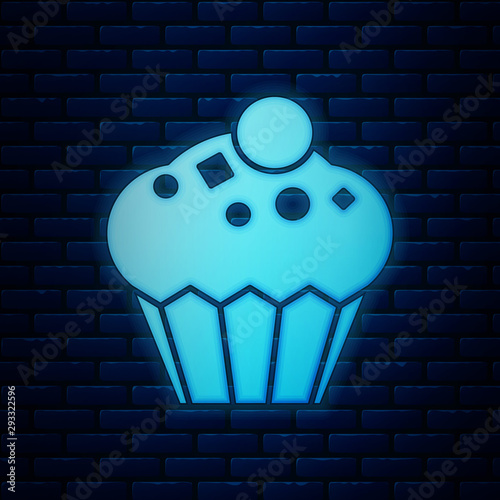 Glowing neon Muffin icon isolated on brick wall background. Vector Illustration