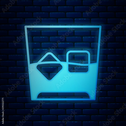 Glowing neon Glass of whiskey and ice cubes icon isolated on brick wall background. Vector Illustration