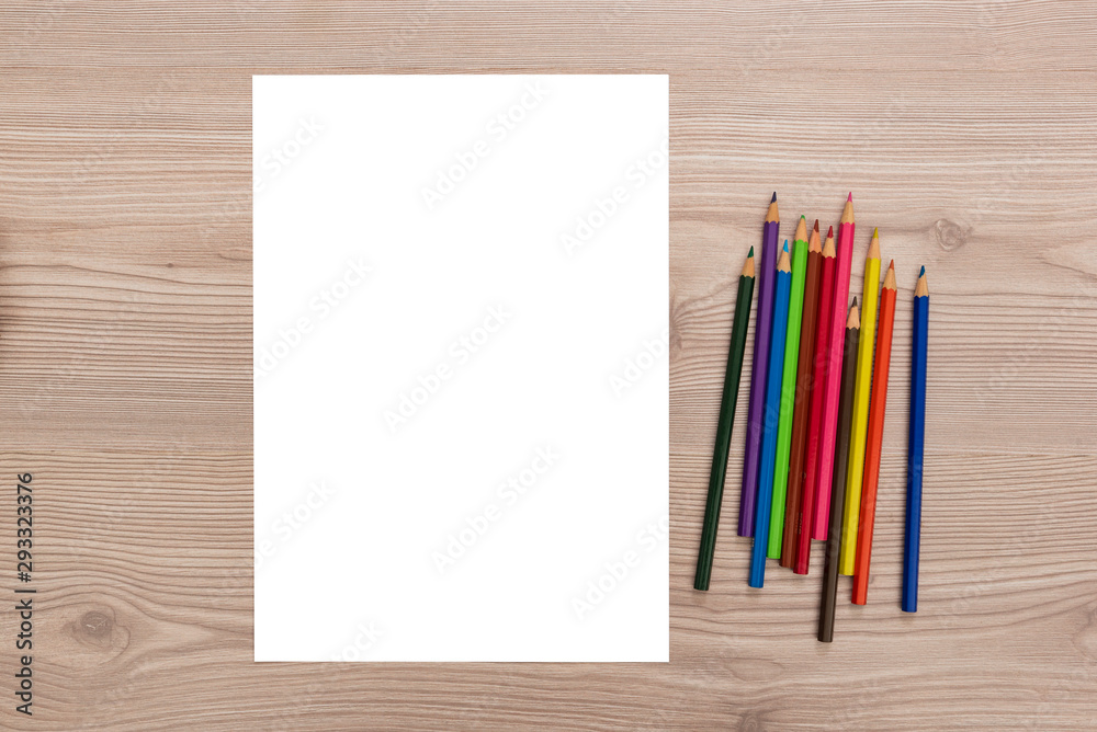 Obraz premium Blank paper, colored pencils on desk 