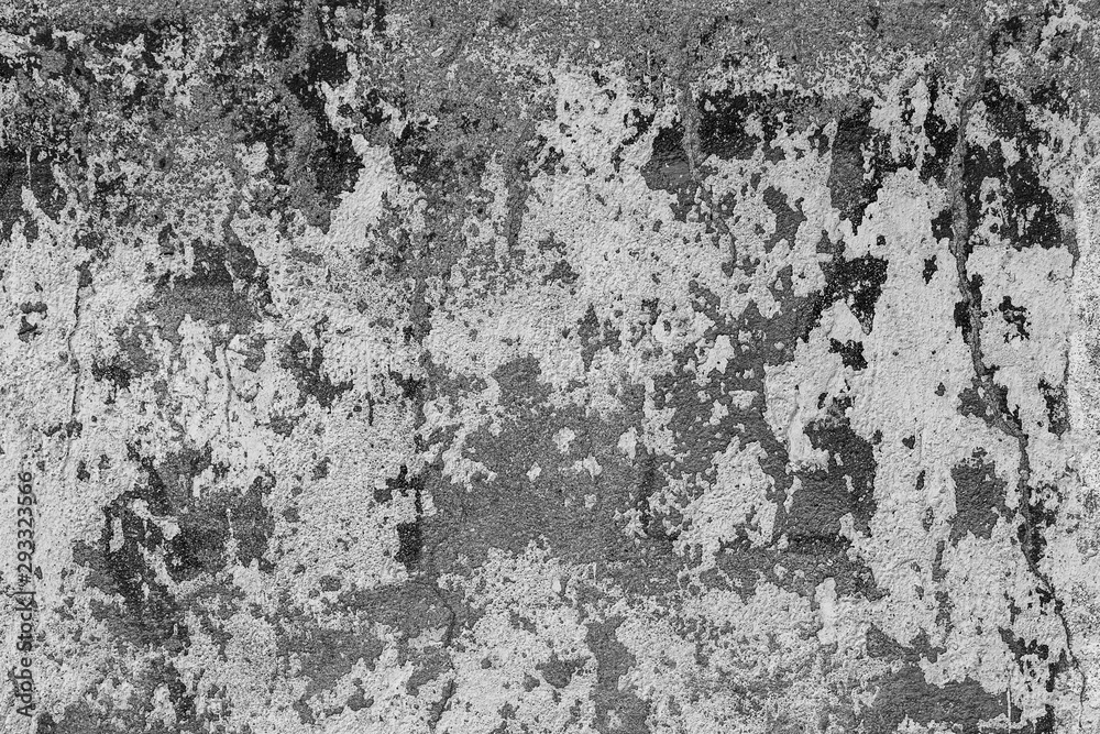 Texture of messy old cracked stone or cement wall in the sunlight for pattern, background. Cracked concrete wall as background. Selective focus old cracked stucco