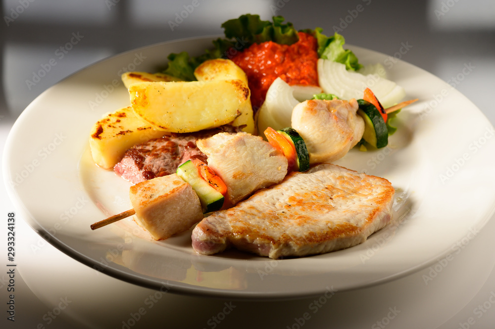 Mixed Grilled meat and vegetables decorated on a plate ready to be served in restaurant Mixed Grilled meat and vegetables decorated on a plate ready to be served in restaurant