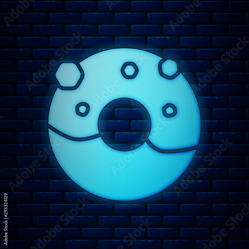 Glowing neon Donut with sweet glaze icon isolated on brick wall background. Vector Illustration