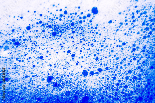 Beautiful abstract texture color white and blue bubbles background in water on blue background pattern clear soapy shiny
