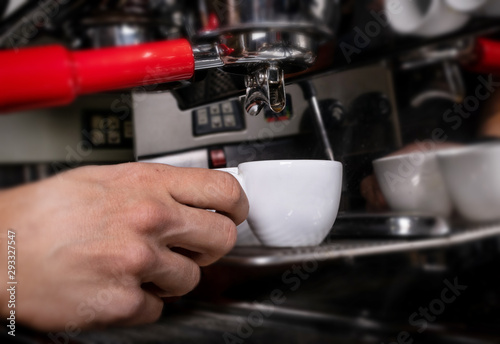 Making espresso in white mug in coffeeshop or cafe closeup