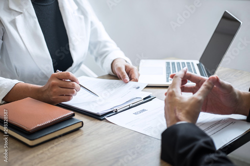 Employer or recruiter holding reading a resume with talking during about his profile of candidate, employer in suit is conducting a job interview, manager resource employment and recruitment concept