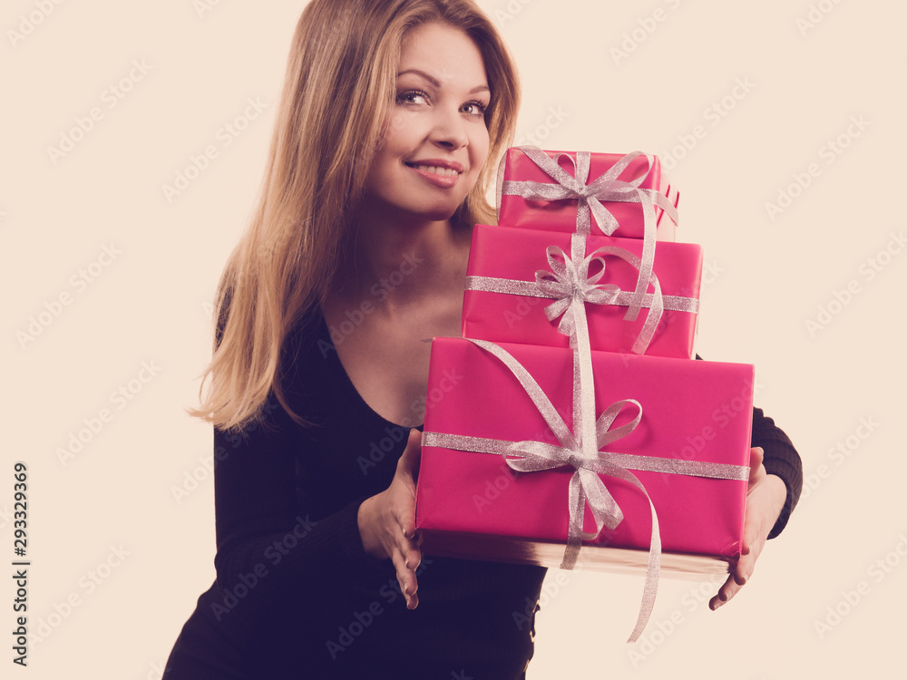 Girl holding stack of pink gift boxes Girl holding stack of pink gift boxes