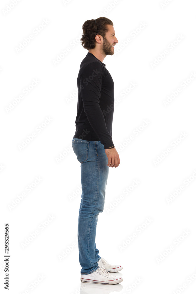 Side View Of Standing Man In Black Jersey, Jeans And Sneakers. Stock Photo  | Adobe Stock