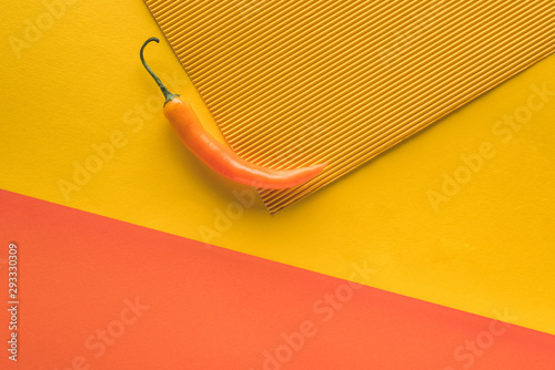 top view of yellow spicy pepper yellow and orange background with copy space