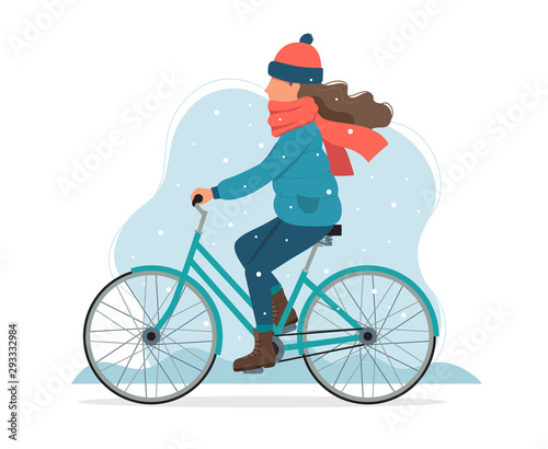 Girl riding a bike in winter. Cute vector illustration in flat style