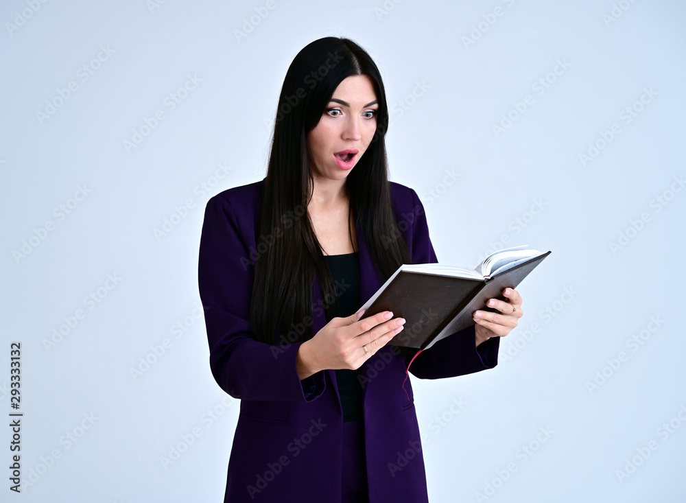 Portrait of a pretty brunette girl with good makeup with long hair on a white background in a business suit with a folder in her hands. Stands in different poses with emotions. Portrait of a pretty brunette girl with good makeup with long hair on a white background in a business suit with a folder in her hands. Stands in different poses with emotions.