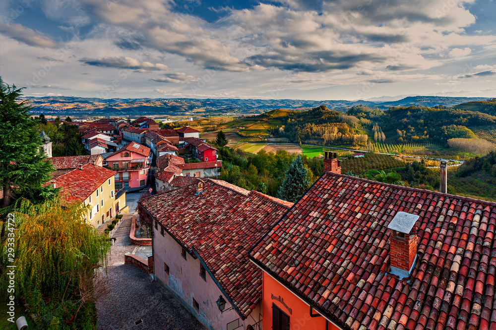 Rural houses and autumnal hills on background in Italy.