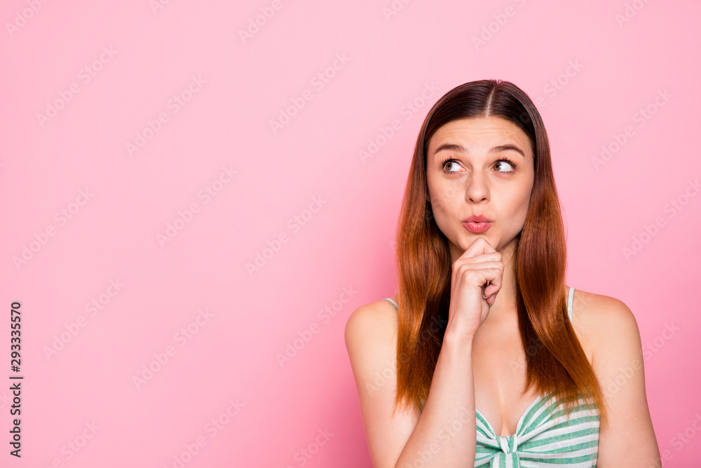 Portrait of cute youth looking touching her chin wearing striped dress skirt isolated over pink background Portrait of cute youth looking touching her chin wearing striped dress skirt isolated over pink background