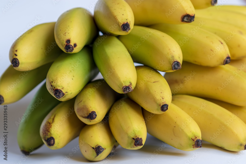 A bunch of small ripe bananas, front view, on white background