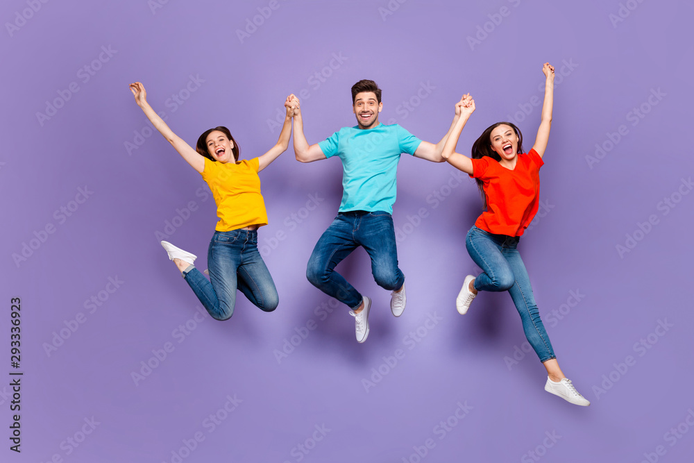 Full length size body photo of three group person having funny mood raising hands up dreams come true isolated violet background Full length size body photo of three group person having funny mood raising hands up dreams come true isolated violet background