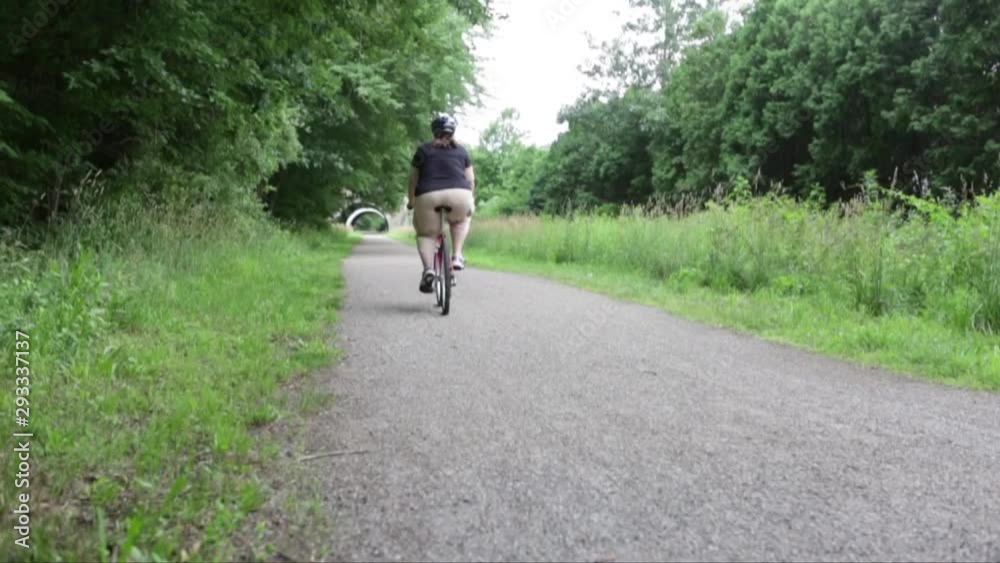 Lifestyle Static low angle clip of a happy couple riding bikes on a rails to trails path on a cloudy day toward the camera Lifestyle Static low angle clip of a happy couple riding bikes on a rails to trails path on a cloudy day toward the camera