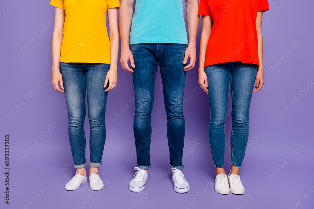 Close up photo of three people standing straight wearing street style clothes isolated violet background Close up photo of three people standing straight wearing street style clothes isolated violet background
