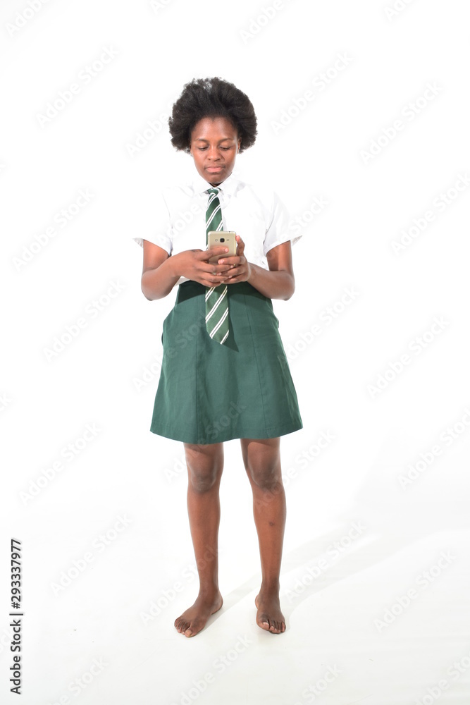portrait of a happy schoolgirl wearing uniform playing with cell phone portrait of a happy schoolgirl wearing uniform playing with cell phone