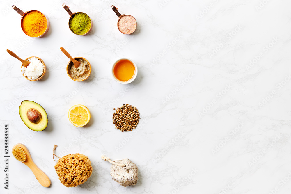 Overhead View Of Natural Beauty And Health Products In Measuring Cups On Marble Background Overhead View Of Natural Beauty And Health Products In Measuring Cups On Marble Background