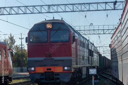 The locomotive drags a heavy freight train.