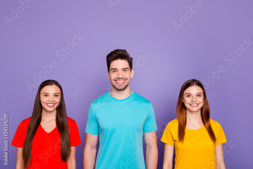 Portrait of nice-looking attractive lovely cheerful cheery glad confident guys wearing colorful t-shirts isolated over violet lilac background