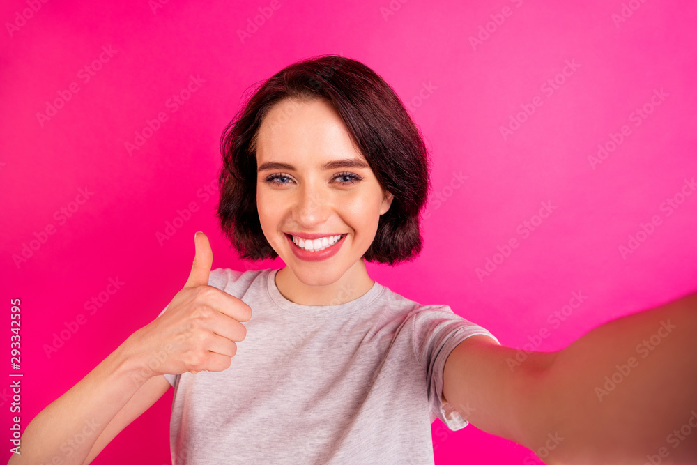 Self photo of cheerful cute nice pretty sweet attractive girlfriend smiling toothily thumbing up to show how high quality is while isolated with fuchsia bright color background taking selfie Self photo of cheerful cute nice pretty sweet attractive girlfriend smiling toothily thumbing up to show how high quality is while isolated with fuchsia bright color background taking selfie