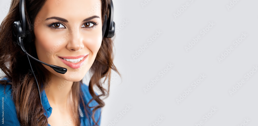 Call center. Portrait of smiling support phone operator in headset, over grey background, with copy space for some text.. Call center. Portrait of smiling support phone operator in headset, over grey background, with copy space for some text..