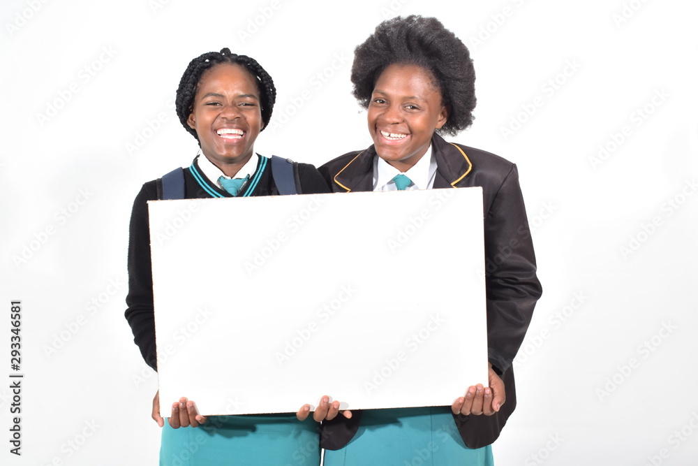 happy beautiful school girls with backpack isolated on white background holding a white board happy beautiful school girls with backpack isolated on white background holding a white board