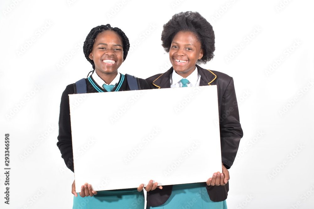 happy beautiful school girls with backpack isolated on white background holding a white board happy beautiful school girls with backpack isolated on white background holding a white board