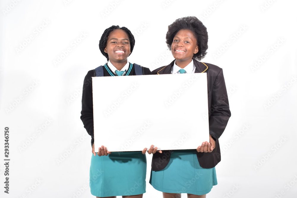 happy beautiful school girls with backpack isolated on white background holding a white board happy beautiful school girls with backpack isolated on white background holding a white board