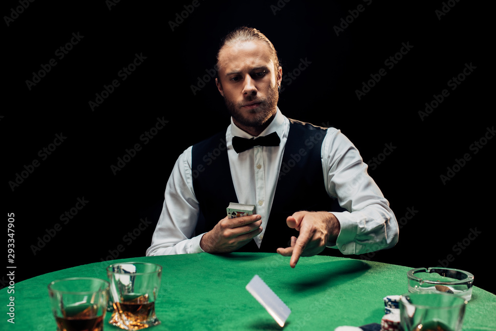 selective focus of bearded man throwing in air playing cards isolated on black selective focus of bearded man throwing in air playing cards isolated on black