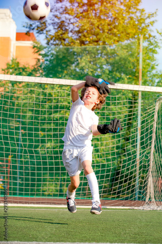 Soccer goalkeeper child in action. jumping soccer goalie. Soccer goalkeeper.goalie. child in action. Goal at the kid soccer match