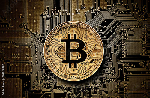 Bitcoin golden coin on computer circuit board  photo
