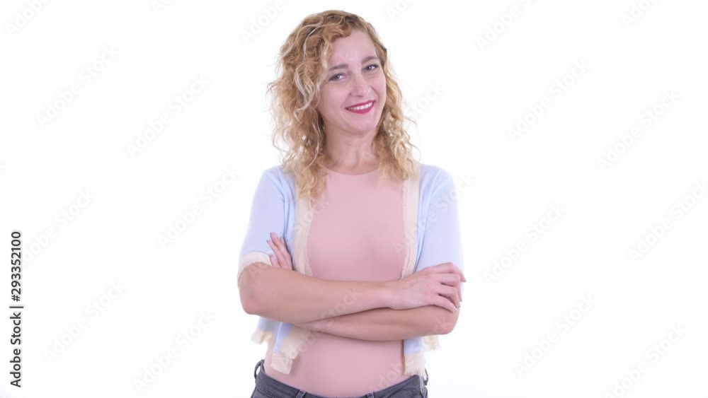 Happy beautiful blonde woman smiling with arms crossed Happy beautiful blonde woman smiling with arms crossed