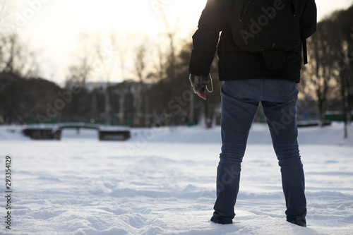 A man walks through the city on snowy winter day.