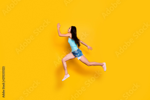 Full length body size photo of cheerful cute nice shopaholic hurrying up for shopping mall weaing jeans denim shorts turquoise tank-top isolated bright color background © deagreez