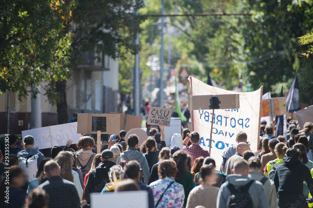 Rear view of people with placards and posters on global strike for climate change. Rear view of people with placards and posters on global strike for climate change.