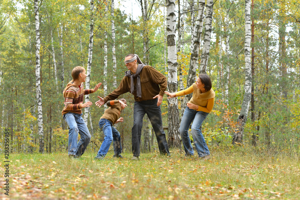Portrait of family of four having fun in autumn forest Portrait of family of four having fun in autumn forest