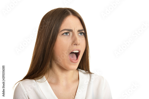 Beautiful woman in white blouse scream on white background