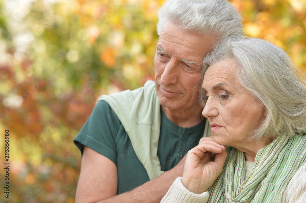 Portrait of a sad senior couple in autumn park Portrait of a sad senior couple in autumn park
