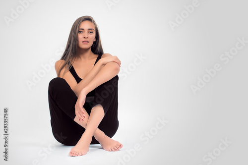 Portrait of a young modern girl in the Studio on a light background, the concept of beauty and fashion
