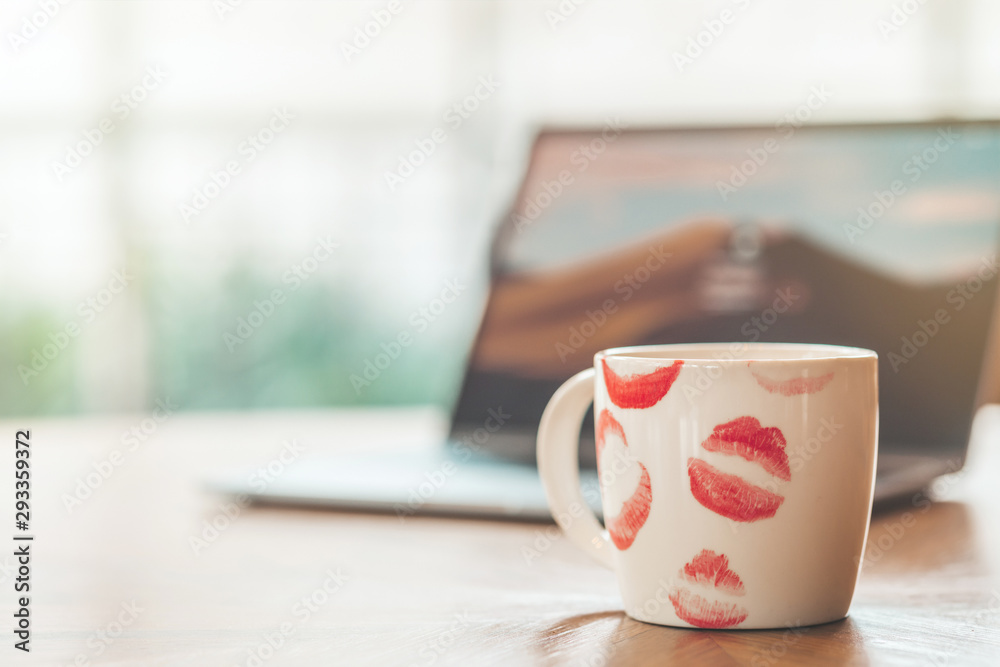 Kisses. A cup of coffee with red lipstick marks. Copy space on the left side